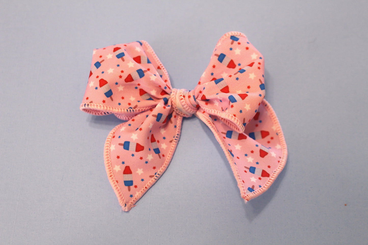 Small pink bomb pop bow